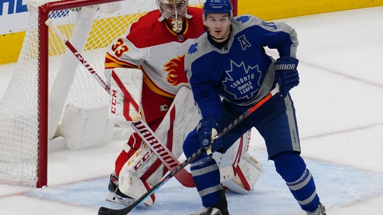 Feb 24, 2021; Toronto, Ontario, CAN; Toronto Maple Leafs forward Zach Hyman (11) screens Calgary Flames goaltender David Rittich (33) during the first period at Scotiabank Arena. Mandatory Credit: John E. Sokolowski-USA TODAY Sports