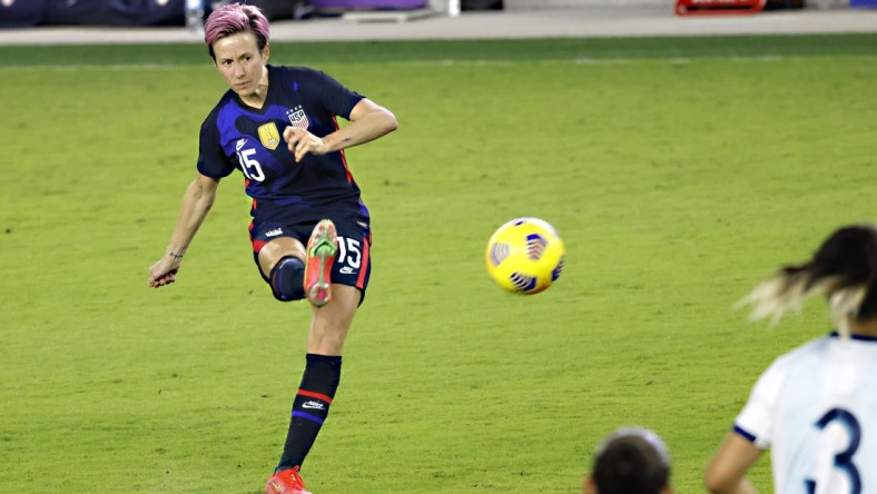 Feb 24, 2021; Orlando, Florida, USA; United States forward Megan Rapinoe (15) kicks the ball during the second half of a She Believes Cup soccer match against Argentina at Exploria Stadium. Mandatory Credit: Reinhold Matay-USA TODAY Sports