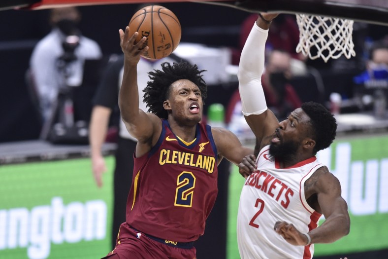 Feb 24, 2021; Cleveland, Ohio, USA; Cleveland Cavaliers guard Collin Sexton (2) drives against Houston Rockets guard David Nwaba (2) in the second quarter at Rocket Mortgage FieldHouse. Mandatory Credit: David Richard-USA TODAY Sports
