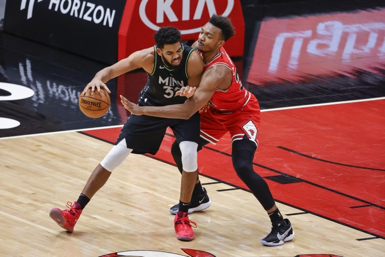 Feb 24, 2021; Chicago, Illinois, USA; Minnesota Timberwolves center Karl-Anthony Towns (32) is defended by Chicago Bulls center Wendell Carter Jr. (34) during the first half of an NBA game at United Center. Mandatory Credit: Kamil Krzaczynski-USA TODAY Sports