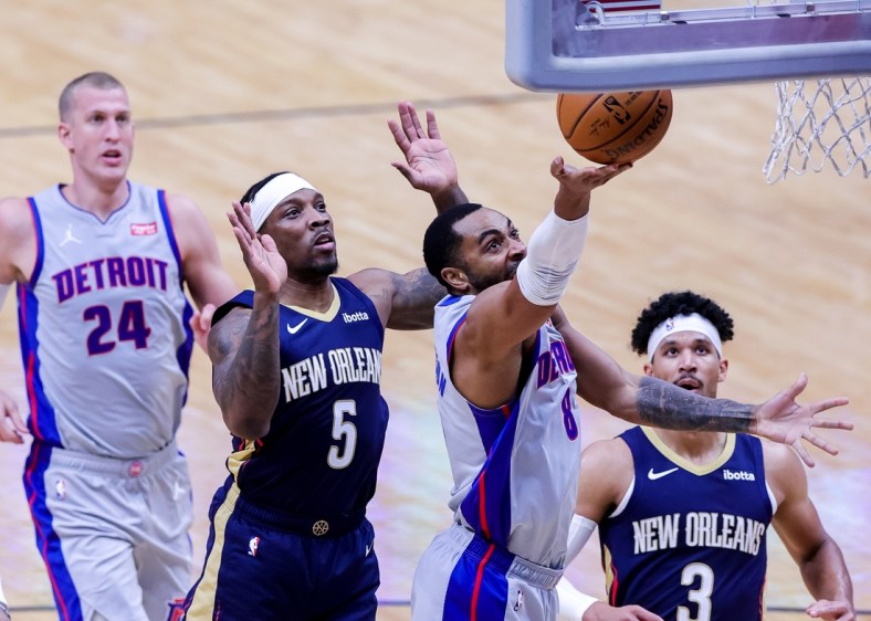 Feb 24, 2021; New Orleans, Louisiana, USA;  Detroit Pistons guard Wayne Ellington (8) drives to the basket against New Orleans Pelicans guard Eric Bledsoe (5) during the first half at Smoothie King Center. Mandatory Credit: Stephen Lew-USA TODAY Sports