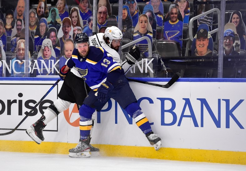 Feb 24, 2021; St. Louis, Missouri, USA;  St. Louis Blues left wing Kyle Clifford (13) checks Los Angeles Kings defenseman Drew Doughty (8) during the first period at Enterprise Center. Mandatory Credit: Jeff Curry-USA TODAY Sports