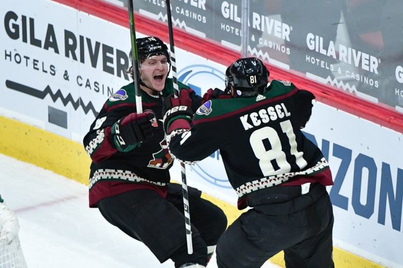 Feb 24, 2021; Glendale, Arizona, USA; Arizona Coyotes right wing Phil Kessel (81) celebrates with center Christian Dvorak (18) after scoring a goal in the third period against the Anaheim Ducks at Gila River Arena. Mandatory Credit: Matt Kartozian-USA TODAY Sports