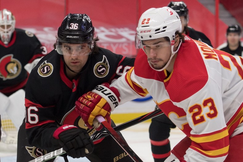Feb 25, 2021; Ottawa, Ontario, CAN; Ottawa Senators center Colin White (36) faces off against Calgary Flames center Sean Monahan (23) in the first period at the Canadian Tire Centre. Mandatory Credit: Marc DesRosiers-USA TODAY Sports