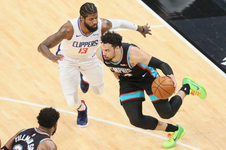 Feb 25, 2021; Memphis, Tennessee, USA; Memphis Grizzlies guard Dillon Brooks (24) dribbles around Los Angeles Clippers guard Paul George (13) in the second quarter at FedExForum. Mandatory Credit: Nelson Chenault-USA TODAY Sports