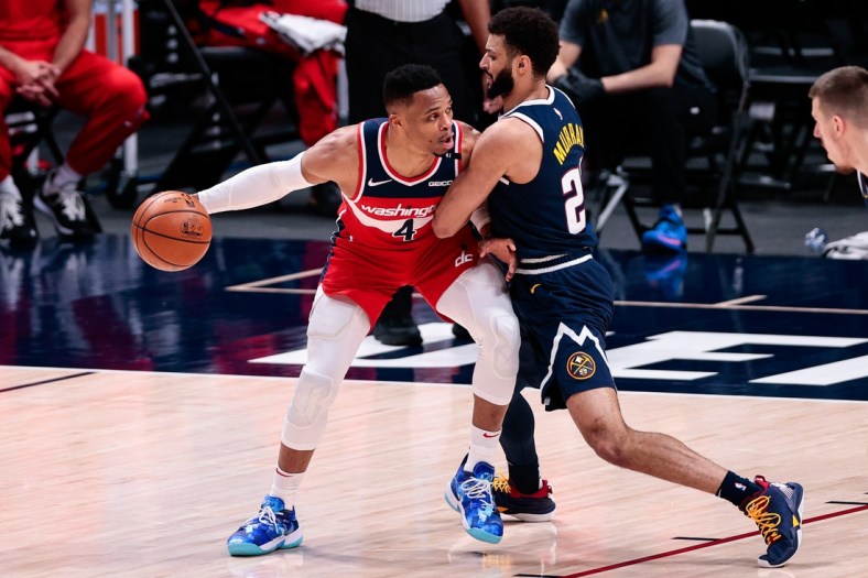 Feb 25, 2021; Denver, Colorado, USA; Washington Wizards guard Russell Westbrook (4) controls the ball as Denver Nuggets guard Jamal Murray (27) guards in the second quarter at Ball Arena. Mandatory Credit: Isaiah J. Downing-USA TODAY Sports