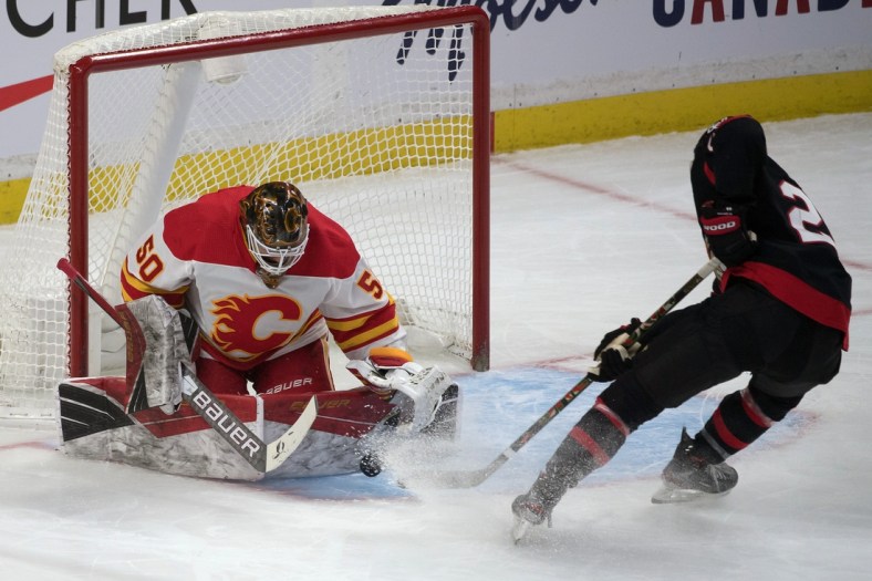 Feb 25, 2021; Ottawa, Ontario, CAN; Ottawa Senators right wing Connor Brown (28) tries to recover the puck on a rebound from Calgary Flames goalie Artyom Zagidulin (50) in the third period at the Canadian Tire Centre. Mandatory Credit: Marc DesRosiers-USA TODAY Sports