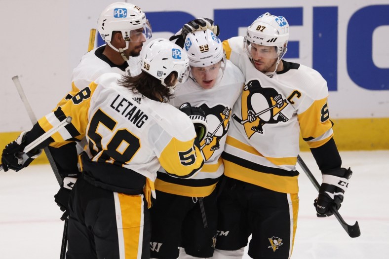 Feb 25, 2021; Washington, District of Columbia, USA; Pittsburgh Penguins left wing Jake Guentzel (59) celebrates with teammates after scoring a goal against the Washington Capitals in the third period at Capital One Arena. Mandatory Credit: Geoff Burke-USA TODAY Sports