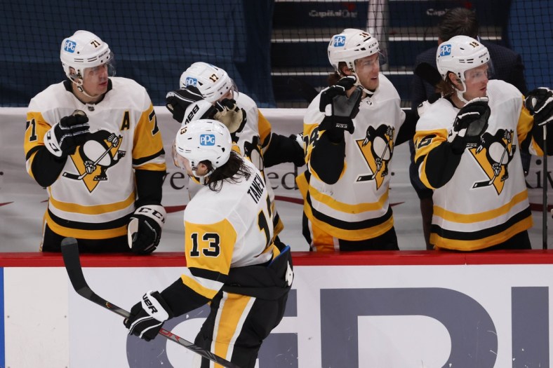 Feb 25, 2021; Washington, District of Columbia, USA; Pittsburgh Penguins left wing Brandon Tanev (13) celebrates with teammates after scoring a goal against the Washington Capitals in the third period at Capital One Arena. Mandatory Credit: Geoff Burke-USA TODAY Sports