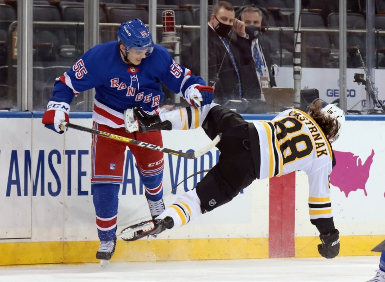 Feb 26, 2021; New York, New York, USA; Ryan Lindgren #55 of the New York Rangers checks David Pastrnak #88 of the Boston Bruins during the first period at Madison Square Garden. Mandatory Credit:  POOL PHOTOS-USA TODAY Sports