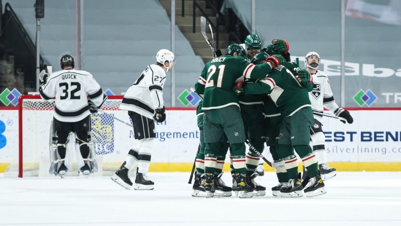 Feb 26, 2021; Saint Paul, Minnesota, USA; The Minnesota Wild celebrate after center Joel Eriksson Ek (14) scored a goal against Los Angeles Kings goaltender Jonathan Quick (32) in the first period at Xcel Energy Center. Mandatory Credit: David Berding-USA TODAY Sports