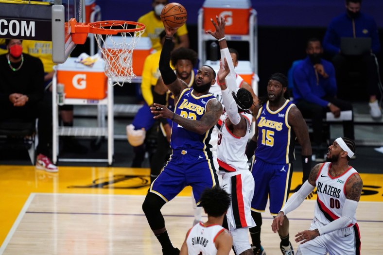 Feb 26, 2021; Los Angeles, California, USA; Los Angeles Lakers forward LeBron James (23) shoots the ball over Portland Trail Blazers forward Robert Covington (23) in the first half at Staples Center. Mandatory Credit: Kirby Lee-USA TODAY Sports