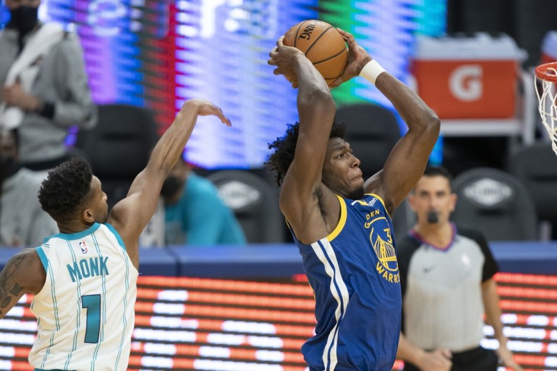 February 26, 2021; San Francisco, California, USA; Golden State Warriors center James Wiseman (33) dunks the basketball against Charlotte Hornets guard Malik Monk (1) during the third quarter at Chase Center. Mandatory Credit: Kyle Terada-USA TODAY Sports