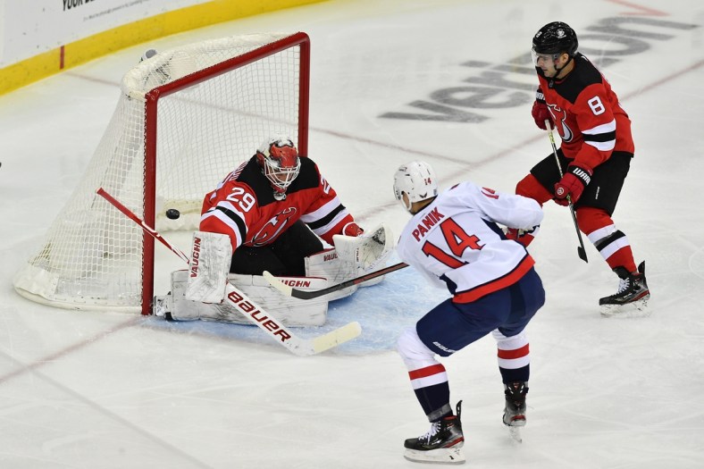 Feb 27, 2021; Newark, New Jersey, USA; New Jersey Devils goalie Mackenzie Blackwood (29) blocks a shot by Washington Capitals right wing Richard Panik (14) during the second period at Prudential Center. Mandatory Credit: Catalina Fragoso-USA TODAY Sports