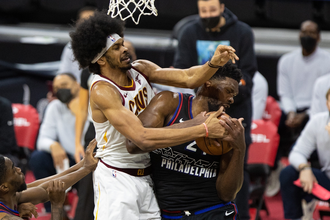 Feb 27, 2021; Philadelphia, Pennsylvania, USA; Philadelphia 76ers center Joel Embiid (21) controls a rebound against Cleveland Cavaliers center Jarrett Allen (31) during the second quarter at Wells Fargo Center. Mandatory Credit: Bill Streicher-USA TODAY Sports