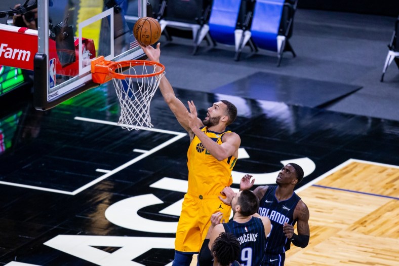 Feb 27, 2021; Orlando, Florida, USA; Utah Jazz center Rudy Gobert (27) attempts a layup during the first quarter of a game between the Orlando Magic and the Utah Jazz at Amway Center. Mandatory Credit: Mary Holt-USA TODAY Sports