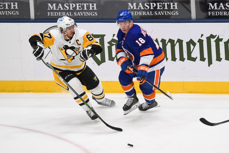Feb 27, 2021; Uniondale, New York, USA; New York Islanders left wing Anthony Beauvillier (18) and Pittsburgh Penguins center Sidney Crosby (87) battle for a loose puck during the second period between the New York Islanders and the Pittsburgh Penguins at Nassau Veterans Memorial Coliseum. Mandatory Credit: Dennis Schneidler-USA TODAY Sports