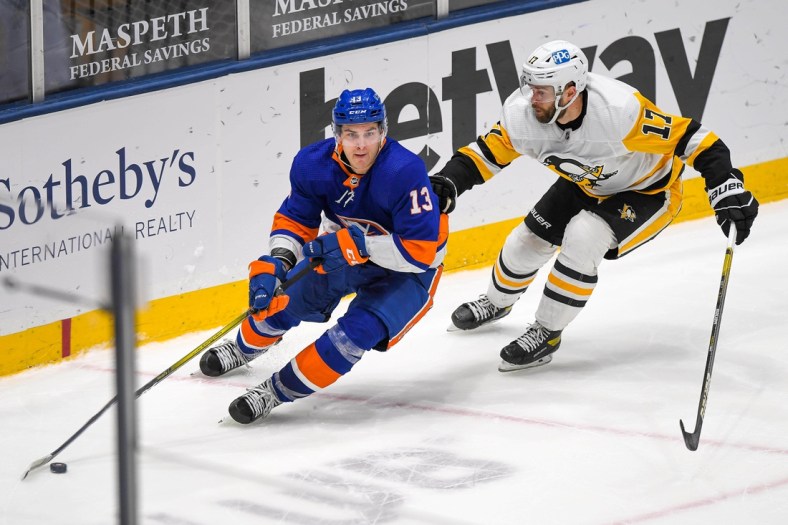 Feb 27, 2021; Uniondale, New York, USA; Pittsburgh Penguins right wing Bryan Rust (17) chases New York Islanders center Mathew Barzal (13) during the third period at Nassau Veterans Memorial Coliseum. Mandatory Credit: Dennis Schneidler-USA TODAY Sports