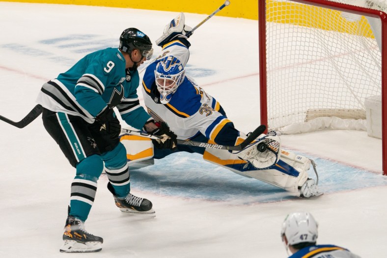 Feb 27, 2021; San Jose, California, USA;  St. Louis Blues goaltender Ville Husso (35) defends the goal during the second period against San Jose Sharks left wing Evander Kane (9) at SAP Center at San Jose. Mandatory Credit: Stan Szeto-USA TODAY Sports