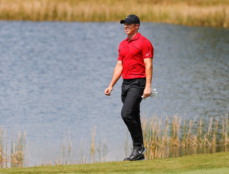 Feb 28, 2021; Bradenton, Florida, USA; Rory McIlroy walks to the second green wearing red and black honoring Tiger Woods during the final round of World Golf Championships at The Concession golf tournament at The Concession Golf Club. Mandatory Credit: Mike Watters-USA TODAY Sports