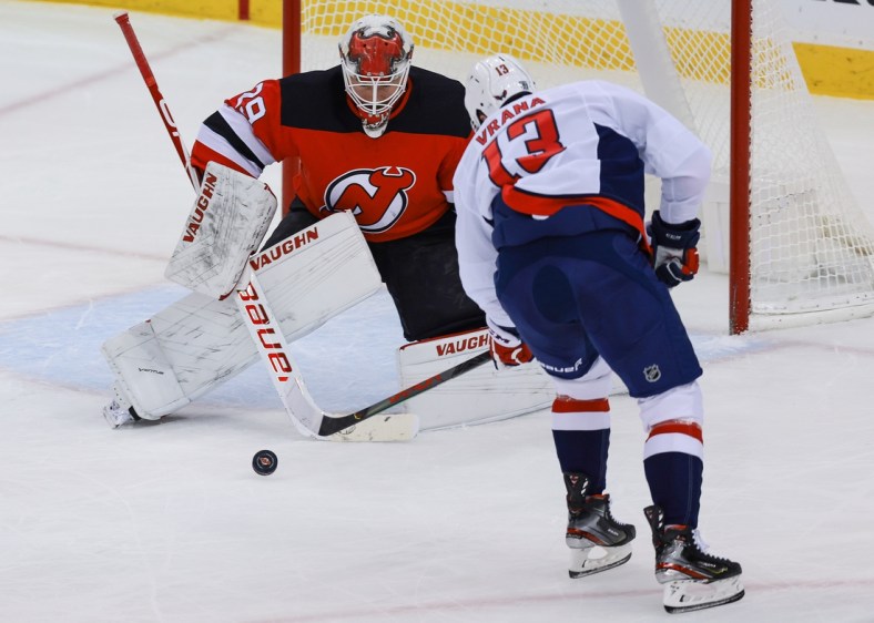 Feb 28, 2021; Newark, New Jersey, USA; Washington Capitals left wing Jakub Vrana (13) scores a goal past New Jersey Devils goaltender Mackenzie Blackwood (29)  during the first period at Prudential Center. Mandatory Credit: Vincent Carchietta-USA TODAY Sports