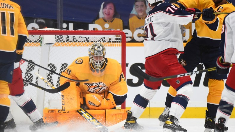 Feb 28, 2021; Nashville, Tennessee, USA; Nashville Predators goaltender Juuse Saros (74) makes a save during the first period against the Columbus Blue Jackets at Bridgestone Arena. Mandatory Credit: Christopher Hanewinckel-USA TODAY Sports