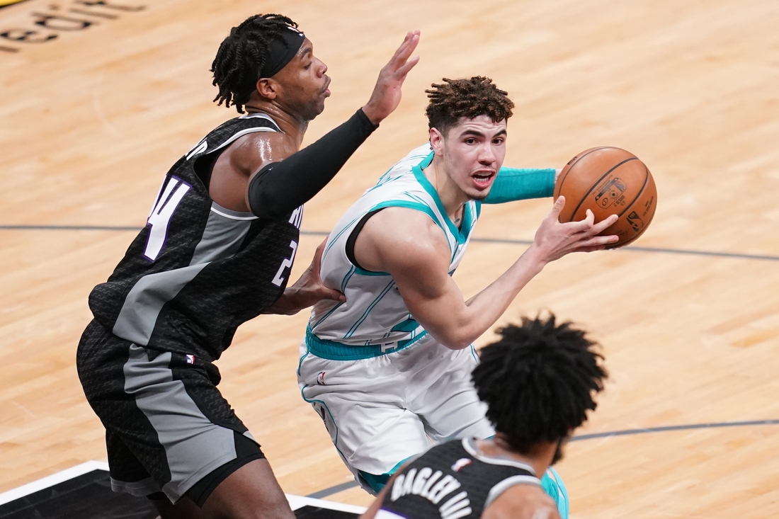 Feb 28, 2021; Sacramento, California, USA; Charlotte Hornets guard LaMelo Ball (2) drives past Sacramento Kings guard Buddy Hield (24) in the second quarter at the Golden 1 Center. Mandatory Credit: Cary Edmondson-USA TODAY Sports