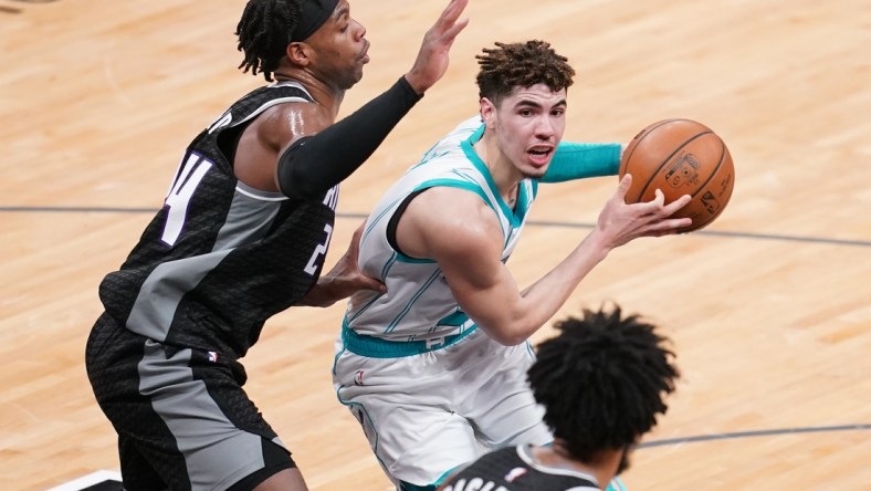 Feb 28, 2021; Sacramento, California, USA; Charlotte Hornets guard LaMelo Ball (2) drives past Sacramento Kings guard Buddy Hield (24) in the second quarter at the Golden 1 Center. Mandatory Credit: Cary Edmondson-USA TODAY Sports