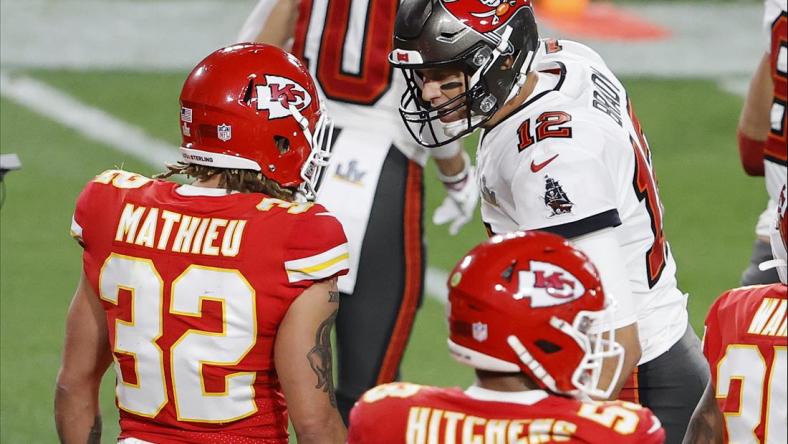 Feb 7, 2020; Tampa, FL, USA; Tampa Bay Buccaneers quarterback Tom Brady (12) talks with Kansas City Chiefs strong safety Tyrann Mathieu (32) during the second quarter of Super Bowl LV at Raymond James Stadium. Mandatory Credit: Kim Klement-USA TODAY Sports