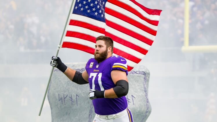 Nov 19, 2017; Minneapolis, MN, USA; Minnesota Vikings offensive lineman Riley Reiff (71) carries the US flag before the game against the Los Angeles Rams at U.S. Bank Stadium. Mandatory Credit: Brad Rempel-USA TODAY Sports