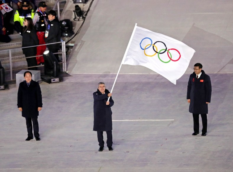 Feb 25, 2018; PyeongChang, South Korea; IOC president Thomas Bach waves the Olympic flag during the closing ceremony for the Pyeongchang 2018 Olympic Winter Games at Pyeongchang Olympic Stadium. Mandatory Credit: Soobum Im-USA TODAY Sports