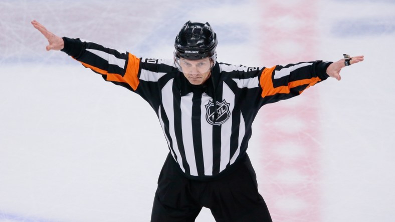 Apr 22, 2018; Denver, CO, USA; Referee Tim Peel (20) waves off a Colorado Avalanche goal in the second period against the Nashville Predators in game six of the first round of the 2018 Stanley Cup Playoffs at the Pepsi Center. Mandatory Credit: Isaiah J. Downing-USA TODAY Sports