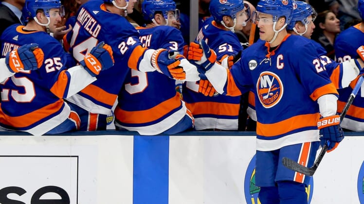 Jan 17, 2019; Uniondale, NY, USA; New York Islanders left wing Anders Lee (27) celebrates with teammates on the bench after scoring a goal against the New Jersey Devils during the first period at Nassau Veterans Memorial Coliseum. Mandatory Credit: Andy Marlin-USA TODAY Sports