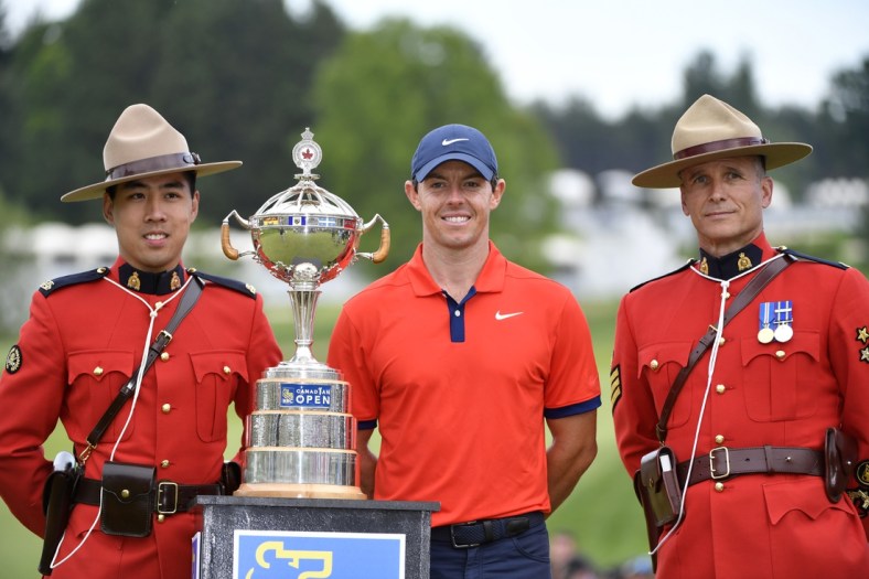 Jun 9, 2019; Hamilton, Ontario, CAN; Rory McIlroy poses with the trophy and two members of the Royal Canadian Mounted Police after winning the 2019 RBC Canadian Open golf tournament at Hamilton Golf & Country Club. Mandatory Credit: Eric Bolte-USA TODAY Sports
