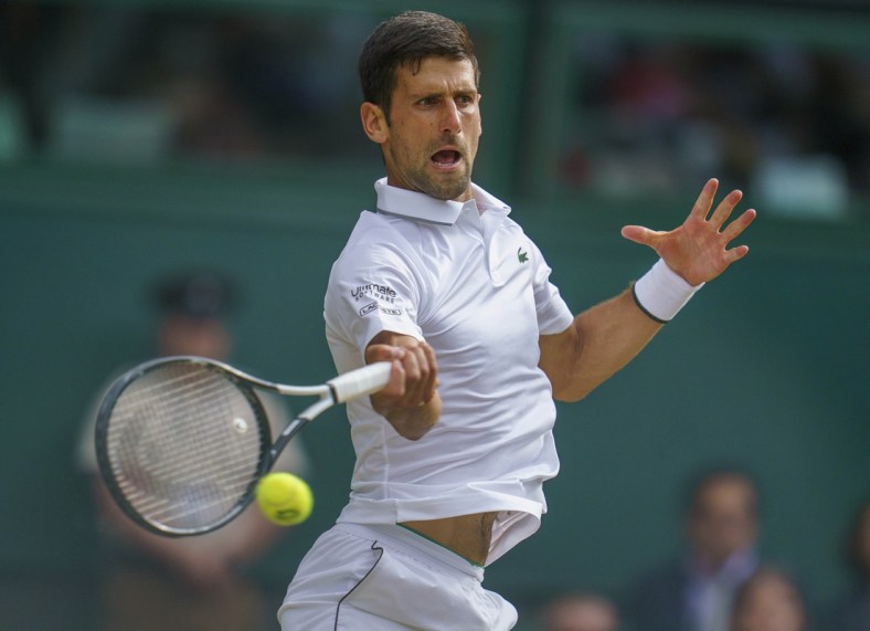 Jul 14, 2019; London, United Kingdom; Novak Djokovic (SRB) in action during the mens final match against Roger Federer (SUI) on day 13 at the All England Lawn and Croquet Club. Mandatory Credit: Susan Mullane-USA TODAY Sports
