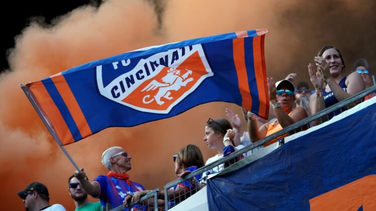 Jul 21, 2019; Cincinnati, OH, USA; A fan of FC Cincinnati waves a team flag in support prior to the game against the New England Revolution at Nippert Stadium. Mandatory Credit: Aaron Doster-USA TODAY Sports