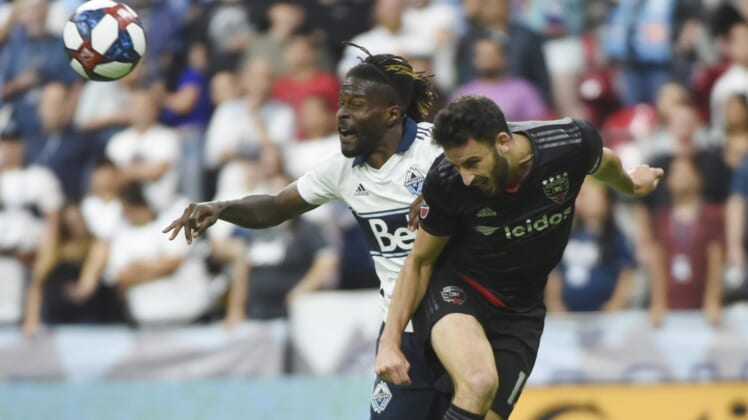 Aug 17, 2019; Vancouver, British Columbia, CAN; DC United defender Steven Birnbaum (15) battles for a header against Vancouver Whitecaps forward Tosaint Ricketts (87) during the second half at BC Place. Mandatory Credit: Anne-Marie Sorvin-USA TODAY Sports