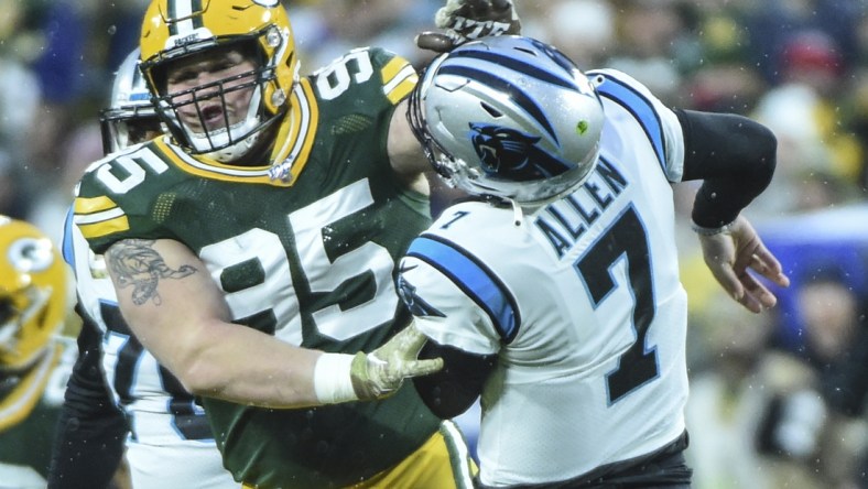 Nov 10, 2019; Green Bay, WI, USA;  Green Bay Packers defensive tackle Tyler Lancaster (95) was penalized for roughing Carolina Panthers quarterback Kyle Allen (7) in the first quarter at Lambeau Field. Mandatory Credit: Benny Sieu-USA TODAY Sports