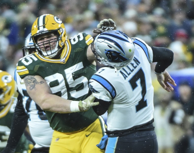 Nov 10, 2019; Green Bay, WI, USA;  Green Bay Packers defensive tackle Tyler Lancaster (95) was penalized for roughing Carolina Panthers quarterback Kyle Allen (7) in the first quarter at Lambeau Field. Mandatory Credit: Benny Sieu-USA TODAY Sports
