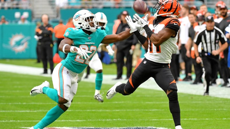 Dec 22, 2019; Miami Gardens, Florida, USA; Cincinnati Bengals wide receiver John Ross (11) hauls in a catch in front of Miami Dolphins defensive back Tae Hayes (22) during the first half at Hard Rock Stadium. Mandatory Credit: Steve Mitchell-USA TODAY Sports