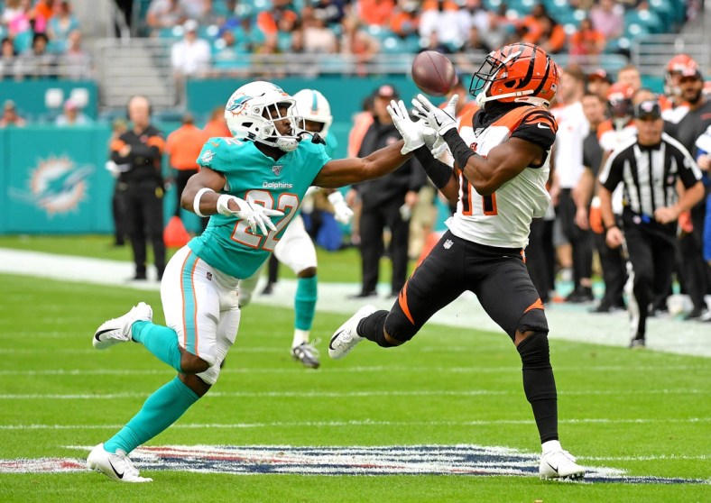 Dec 22, 2019; Miami Gardens, Florida, USA; Cincinnati Bengals wide receiver John Ross (11) hauls in a catch in front of Miami Dolphins defensive back Tae Hayes (22) during the first half at Hard Rock Stadium. Mandatory Credit: Steve Mitchell-USA TODAY Sports