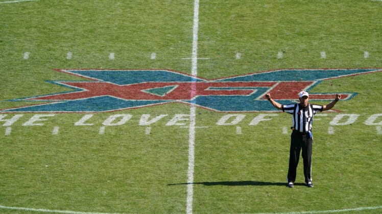 Feb 16, 2020; Carson, California, USA; XFL referee Reggie Smith gestures with the XFL logo as backdrop in the first quarter of the game between the LA Wildcats and the Dallas Renegades at Dignity Health Sports Park.  Mandatory Credit: Kirby Lee-USA TODAY Sports