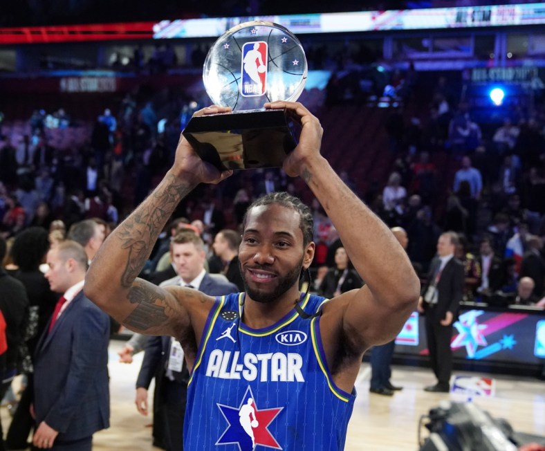 Feb 16, 2020; Chicago, Illinois, USA; Team LeBron forward Kawhi Leonard of the LA Clippers hoists the Kobe Bryant MVP trophy after the 2020 NBA All Star Game at United Center. Mandatory Credit: Kyle Terada-USA TODAY Sports
