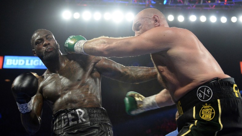 Feb 22, 2020; Las Vegas, Nevada, USA; Deontay Wilder and Tyson Fury box during their WBC heavyweight title bout at MGM Grand Garden Arena. Fury won via seventh round TKO. Mandatory Credit: Joe Camporeale-USA TODAY Sports