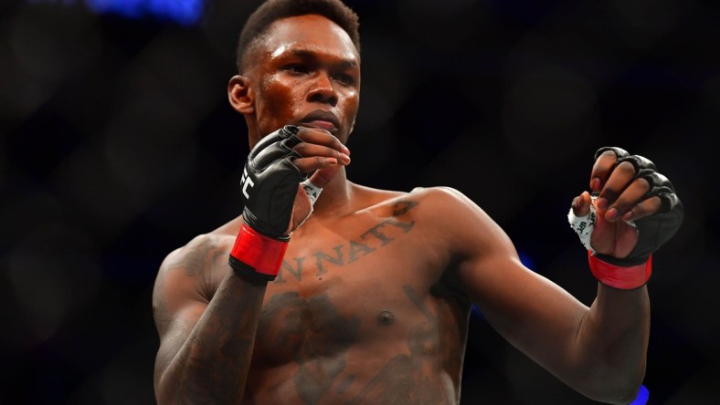 Mar 7, 2020; Las Vegas, Nevada, USA; Israel Adesanya (red gloves) before the match against Yoel Romero (blue gloves) during UFC 248 at T-Mobile Arena. Mandatory Credit: Stephen R. Sylvanie-USA TODAY Sports