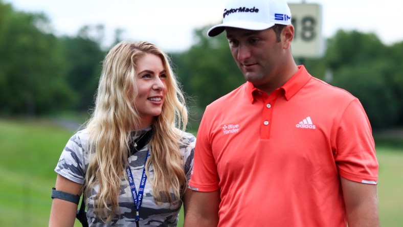 Jul 19, 2020; Dublin, Ohio, USA; Kelley Cahill (left) talks with husband Jon Rahm (right) after he wins The Memorial Tournament at Muirfield Village Golf Club. Mandatory Credit: Aaron Doster-USA TODAY Sports