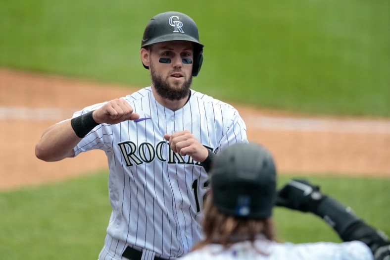 Aug 2, 2020; Denver, Colorado, USA; Colorado Rockies left fielder Chris Owings (left) celebrates with right fielder Charlie Blackmon (19) after scoring against the San Diego in the seventh inning Padres at Coors Field. Mandatory Credit: Isaiah J. Downing-USA TODAY Sports