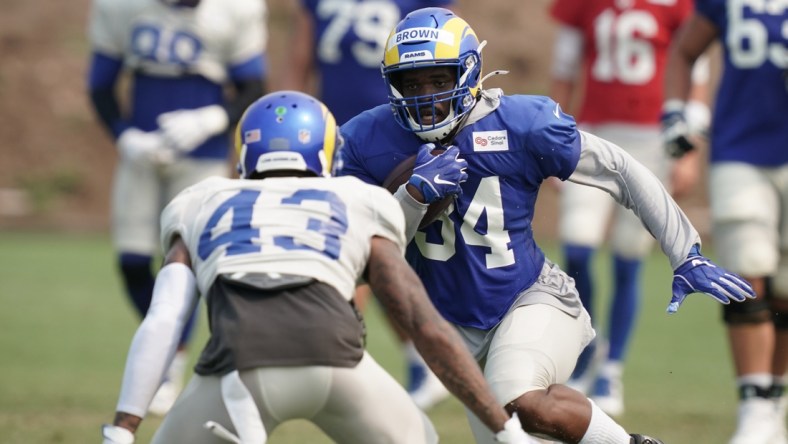 Aug 18, 2020; Thousand Oaks California, USA; Los Angeles Rams running back Malcolm Brown (34) is defended by safety John Johnson III (43) during training camp at Cal Lutheran University. Mandatory Credit: Kirby Lee-USA TODAY Sports