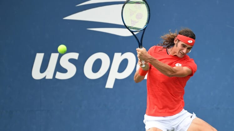 Sep 2, 2020; Flushing Meadows, New York, USA; LloydHarris of South Africa hits a backhand against David Goffin of Belgium (not pictured) on day three of the 2020 U.S. Open tennis tournament at USTA Billie Jean King National Tennis Center. Mandatory Credit: Danielle Parhizkaran-USA TODAY Sports