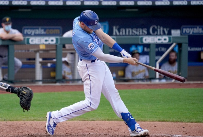 Sep 13, 2020; Kansas City, Missouri, USA; Kansas City Royals first baseman Hunter Dozier (17) connects for a solo home run in the sixth inning against the Pittsburgh Pirates at Kauffman Stadium. Mandatory Credit: Denny Medley-USA TODAY Sports